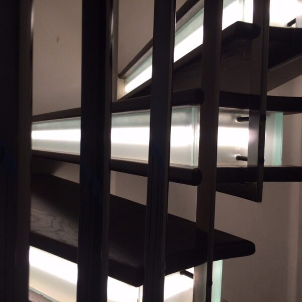 Illuminated treads of cantilevered spiral staircase